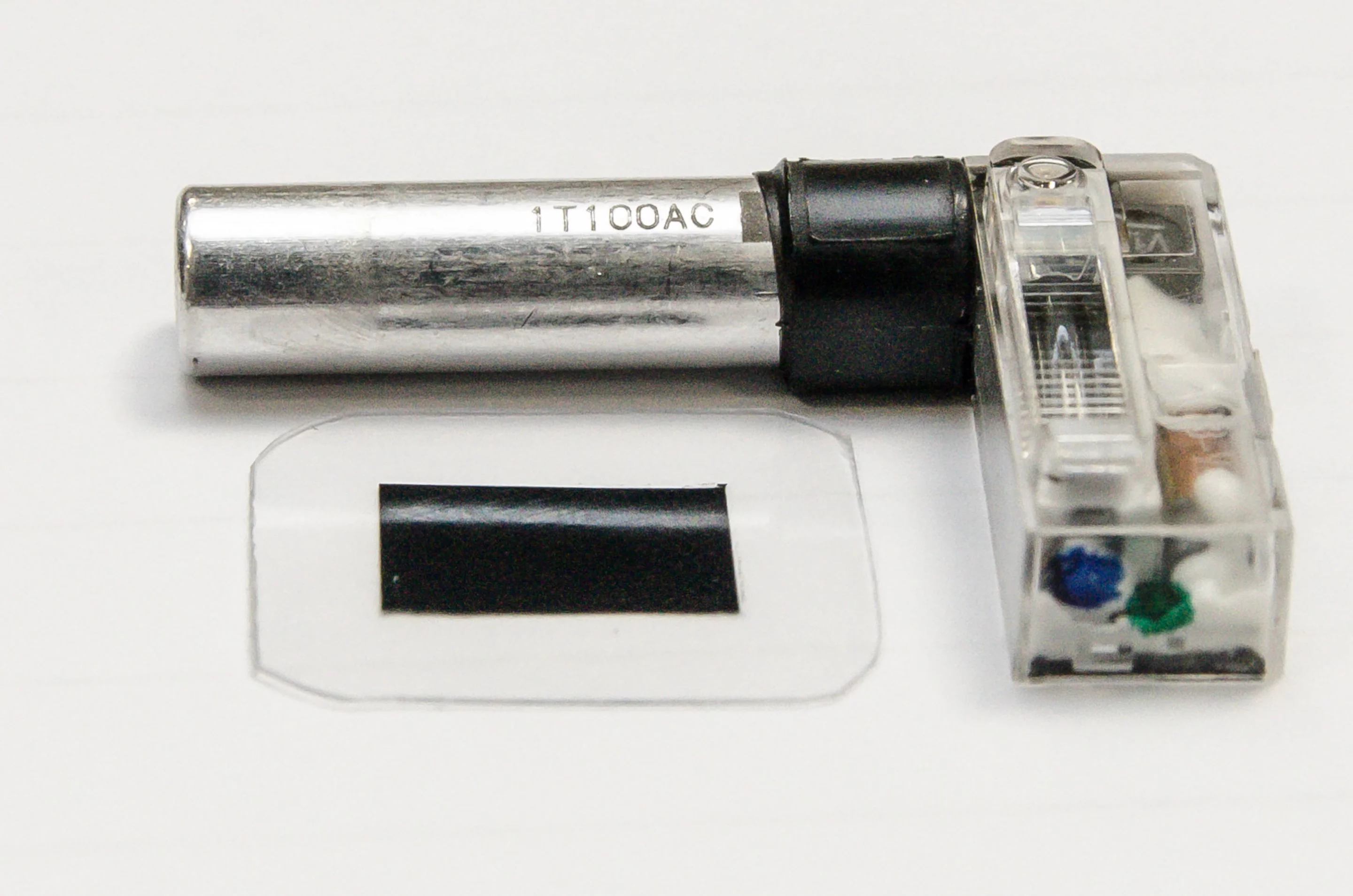 A typical smartphone flash with its existing capacitor (silver cylinder), and the new polymer capacitor material (lower left)