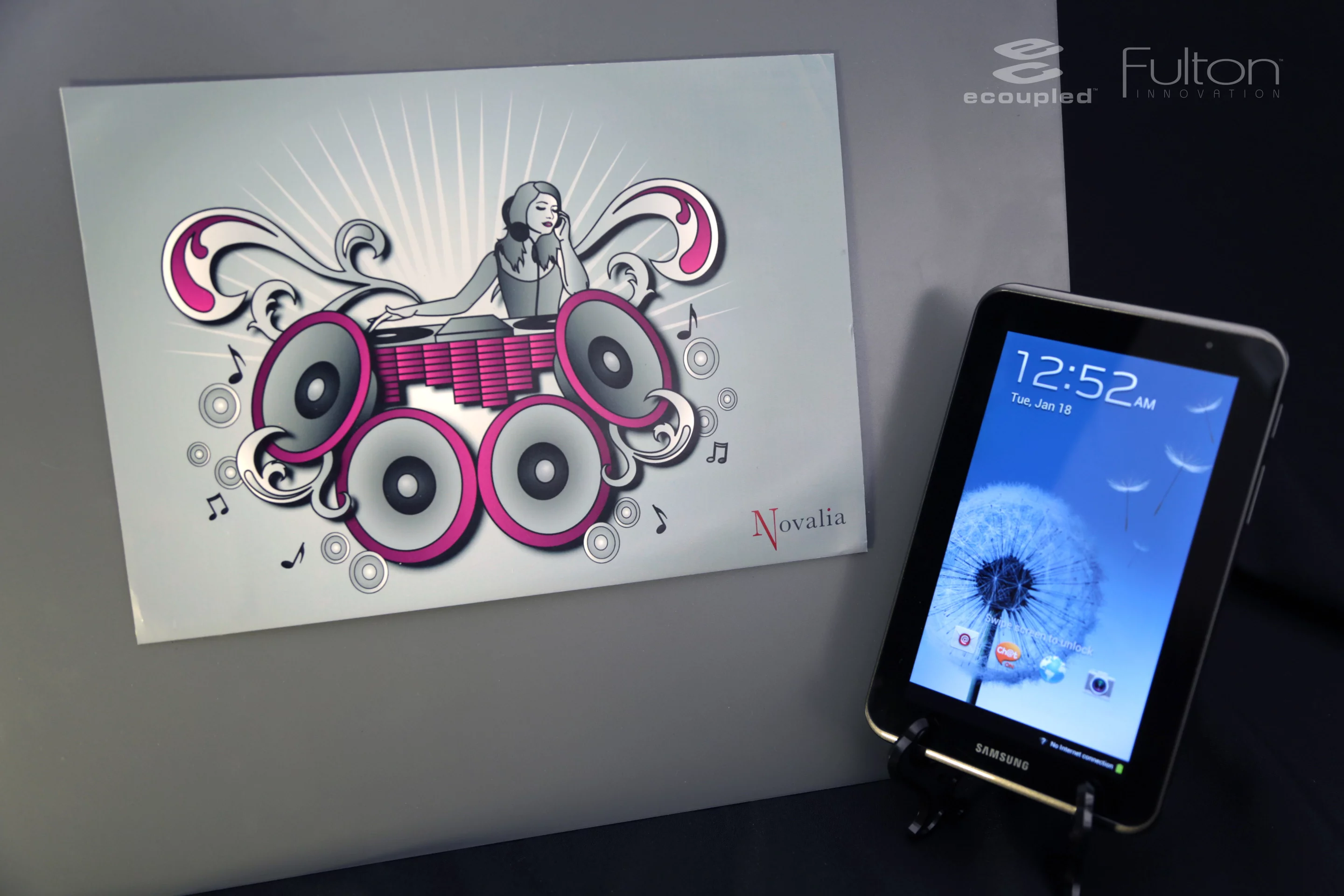 The tablet/smartphone coupling can be placed near an interactive printed poster sporting an image of a DJ console to receive wireless power