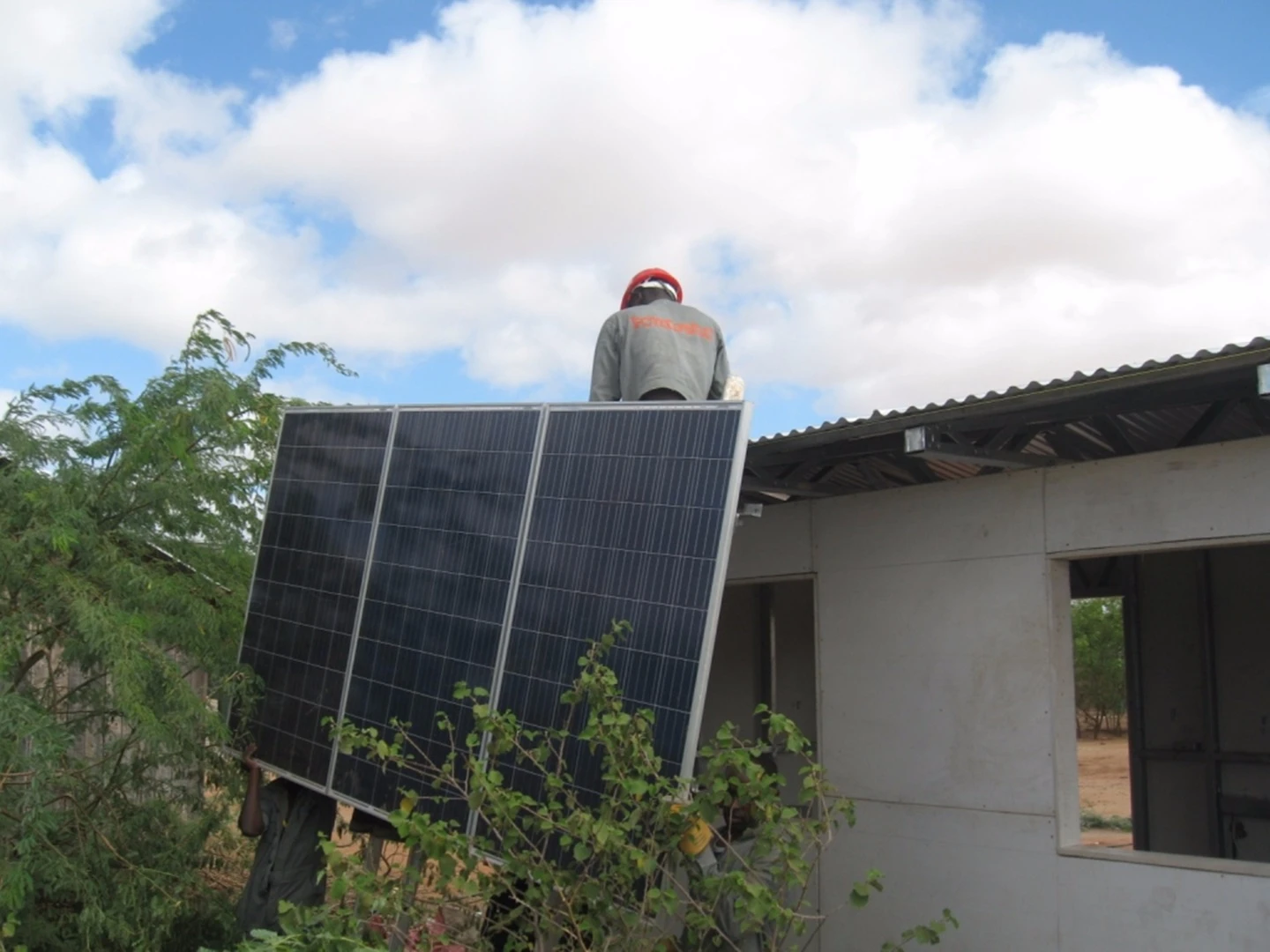 Once the structure is complete, two solar panels are screwed onto mounting rails on the roof