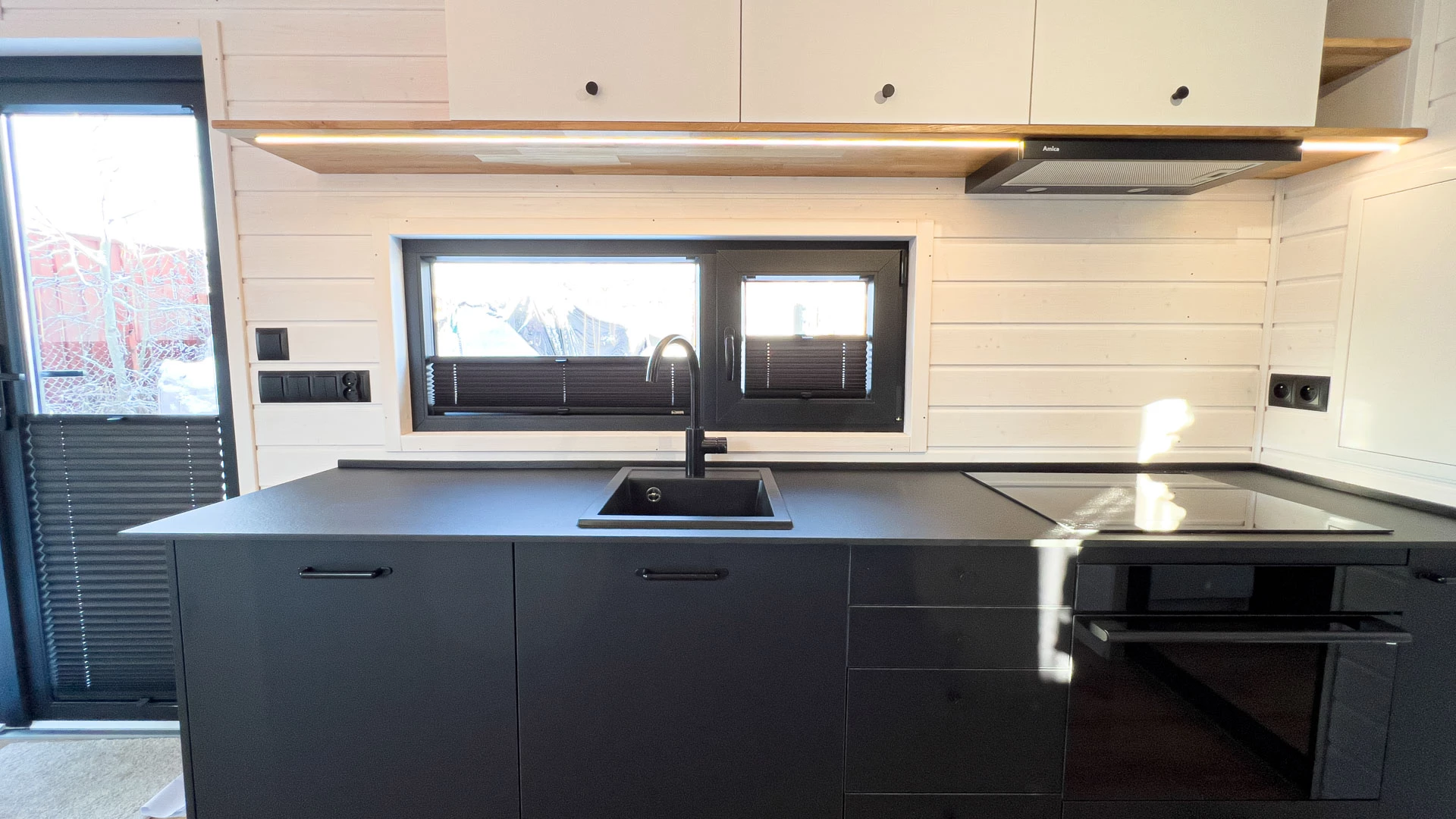 The Mobi Individual Baobab's kitchen includes an oven with induction stove, a sink, and a dishwasher