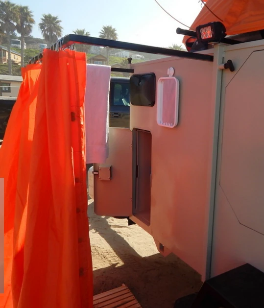 The shower package includes a pull-out curtain bar, magnetic curtain, wooden deck and chair