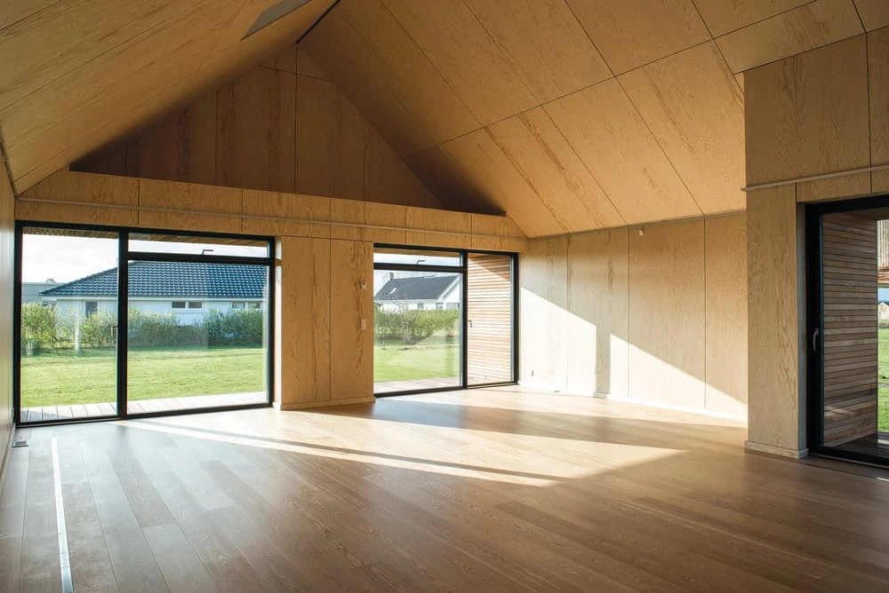 The Maintenance-Free House is a wooden structure completely enveloped by a glass shield, which keeps it safe from the elements
