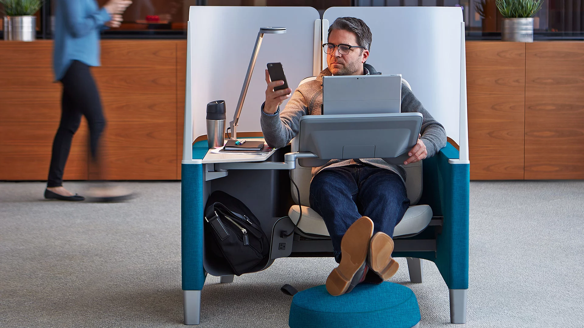 Each workspace is equipped with a main work surface, positioned on a swiveling arm that's adjustable up to 40 degrees of pitch