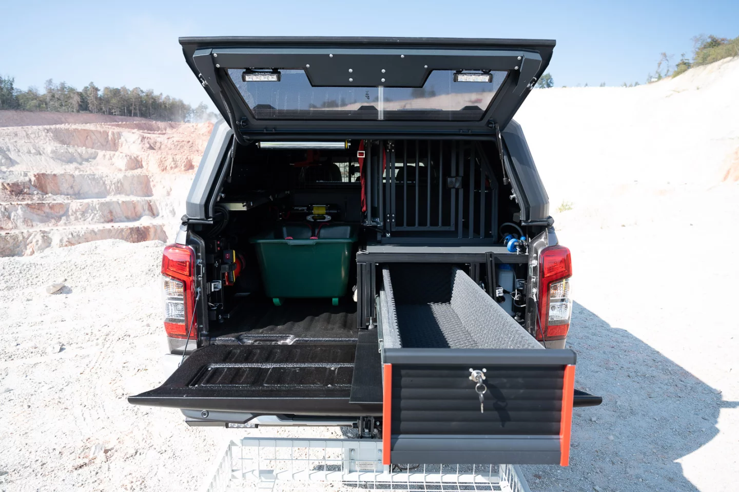 The gun drawer keeps firearms secure, while the dog crate keeps a hunting companion safe and secure
