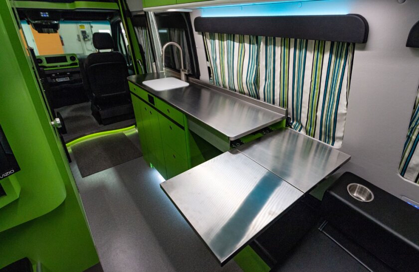 The dining table slides and folds out from below the countertop, doubling as a counter extension