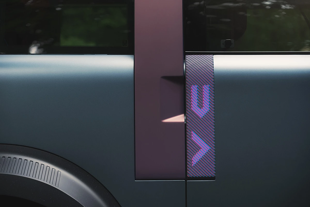 That purple striped panel is actually a canvas strap that serves as a door handle