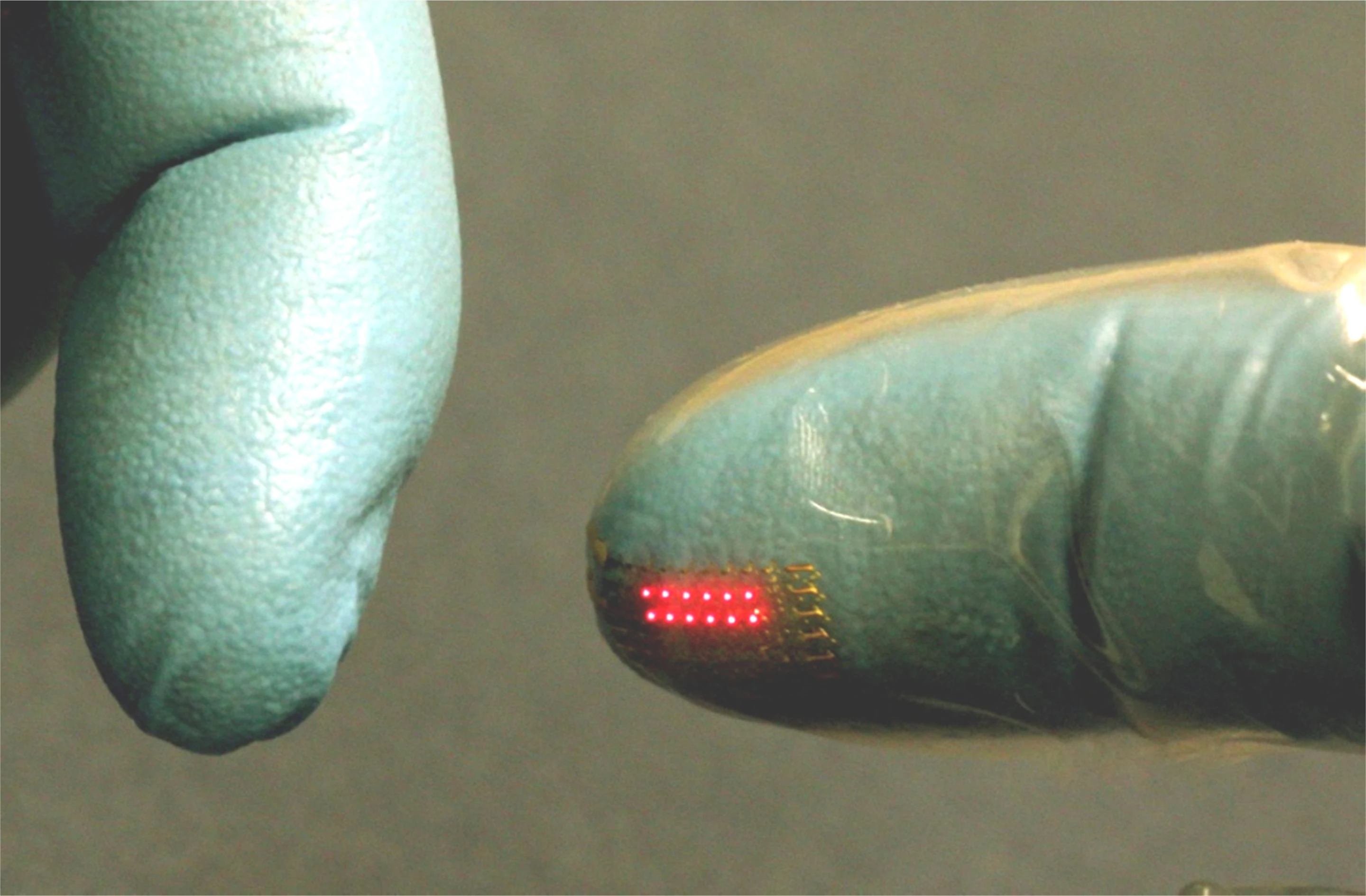 An LED array, transfer printed onto the fingertip of a vinyl glove