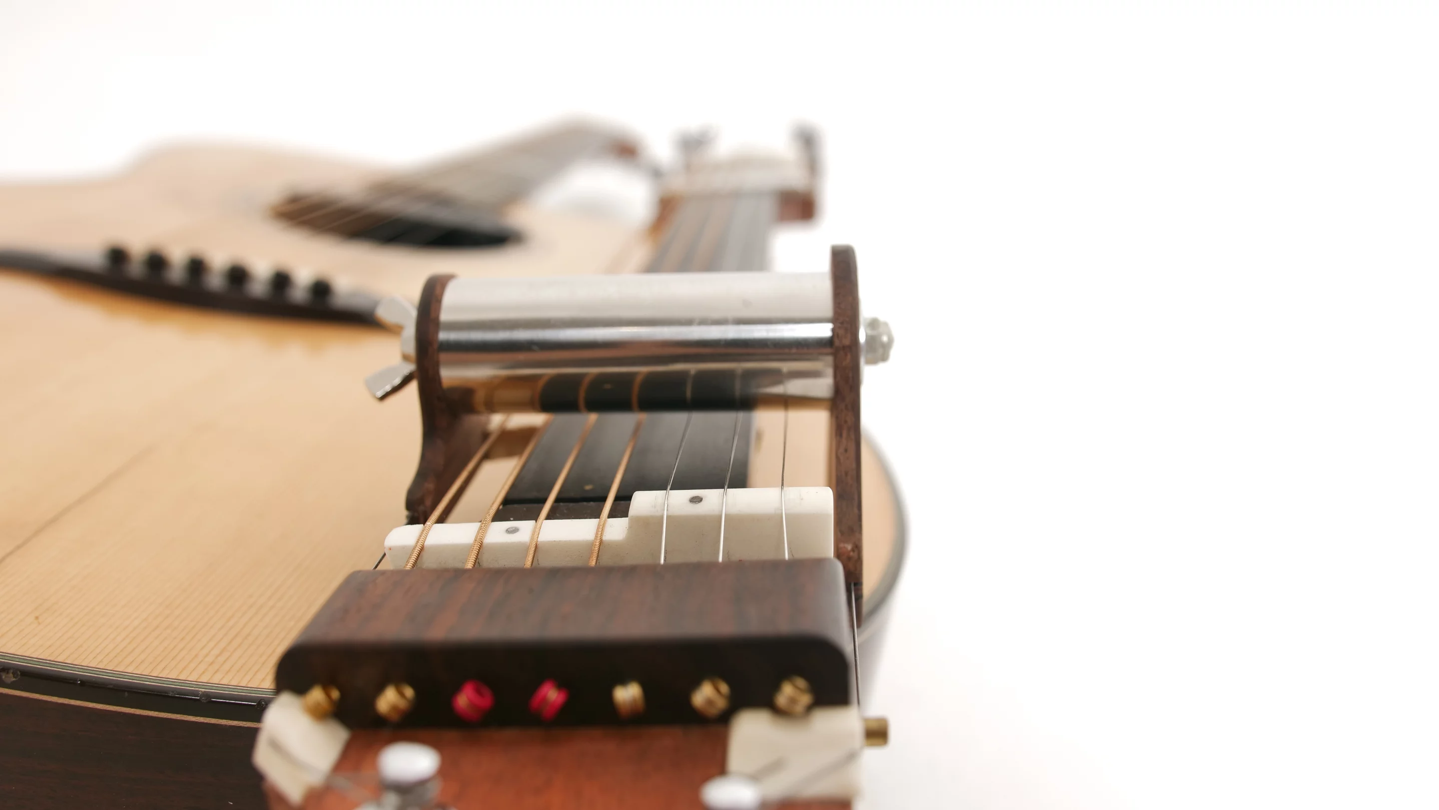 The four bass strings ride lower so that they are not influenced by the slide mechanism