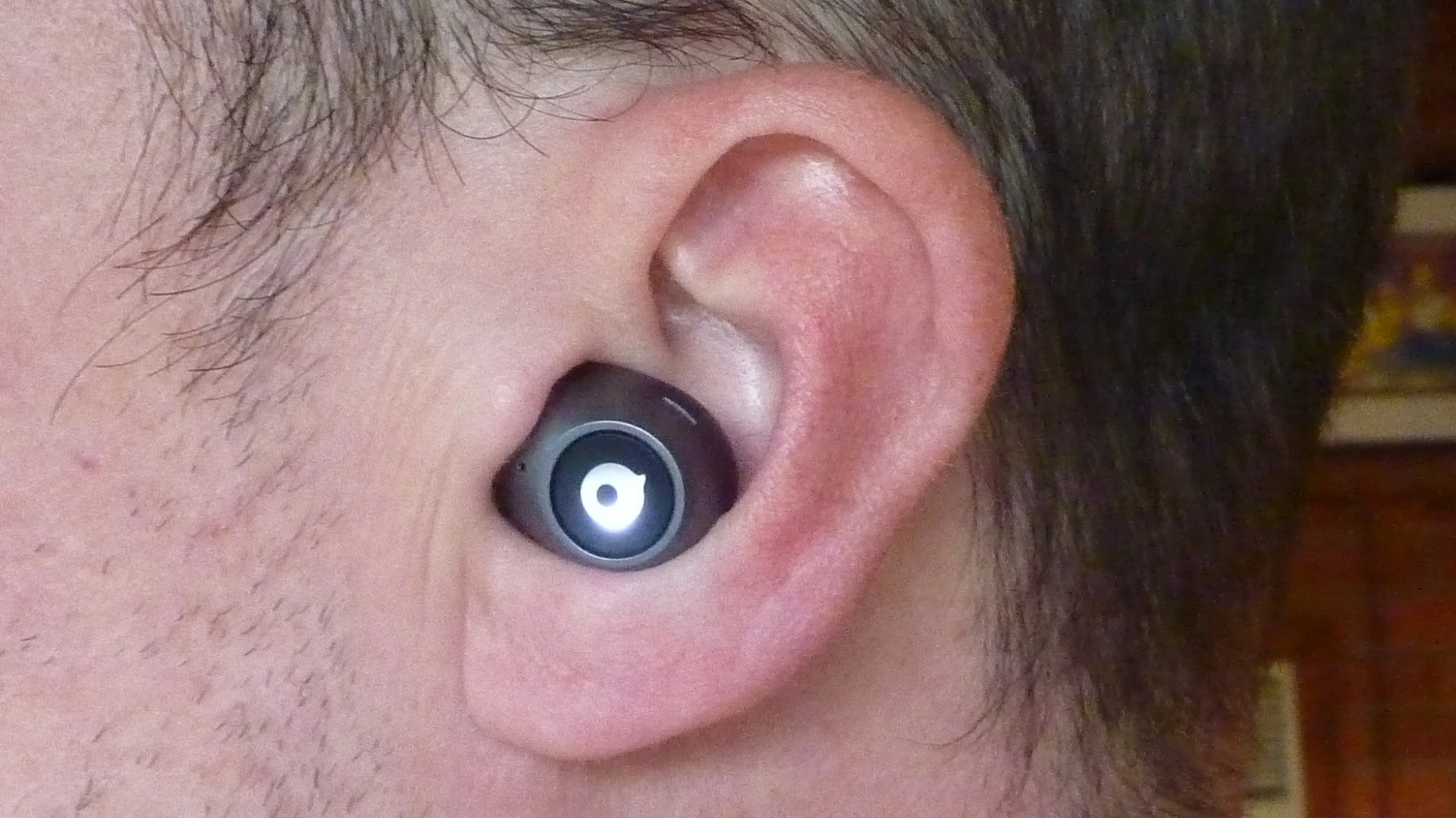 The Crazybaby 1S earbuds display a pulsating light when on