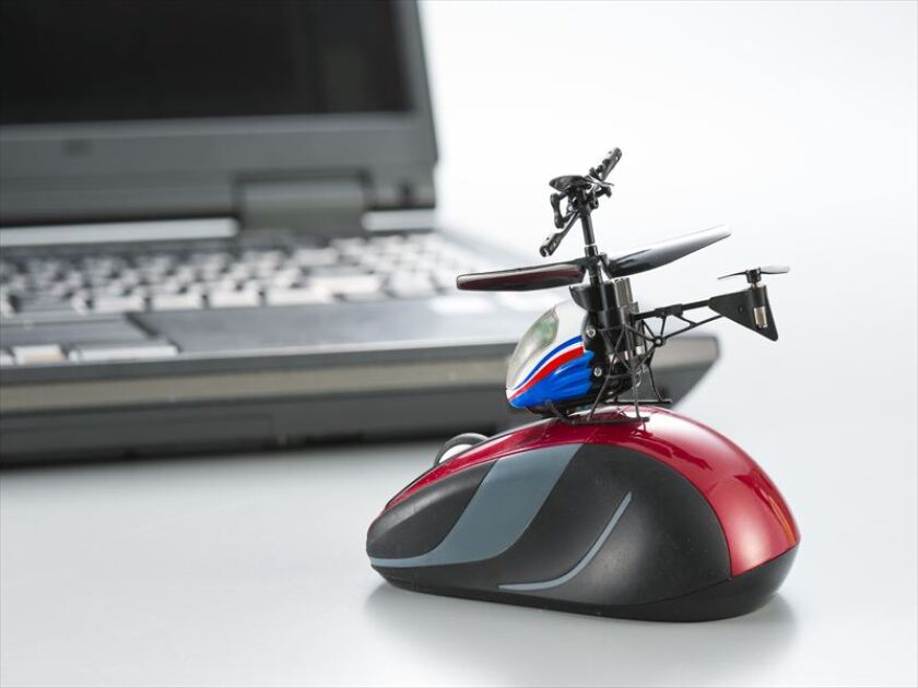 A standard computer mouse dwarfs the Nano-Falcon