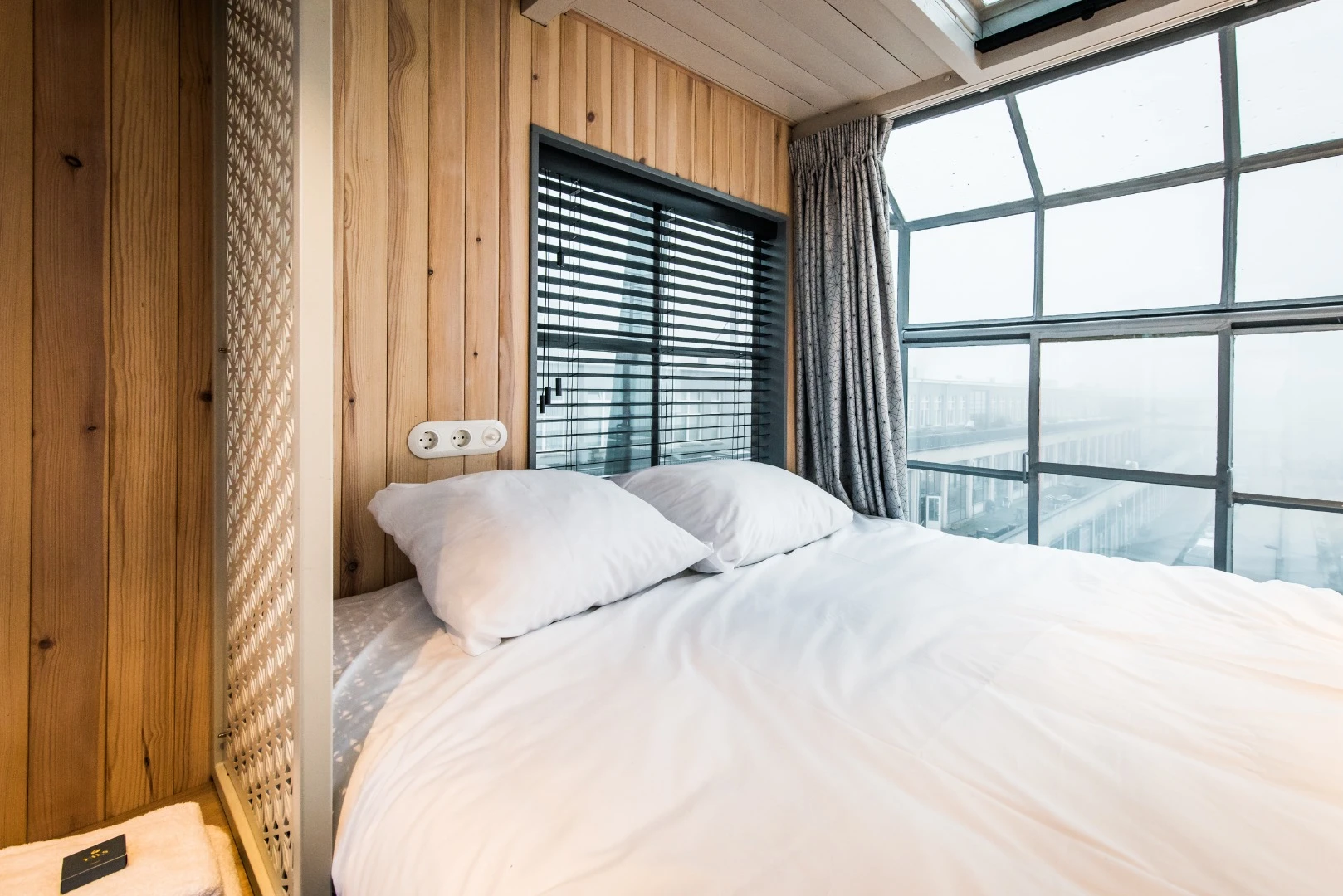 The glazing in the Yays – Crane Apartment's uppermost bedroom is the original window the crane operator would use to see what he was doing