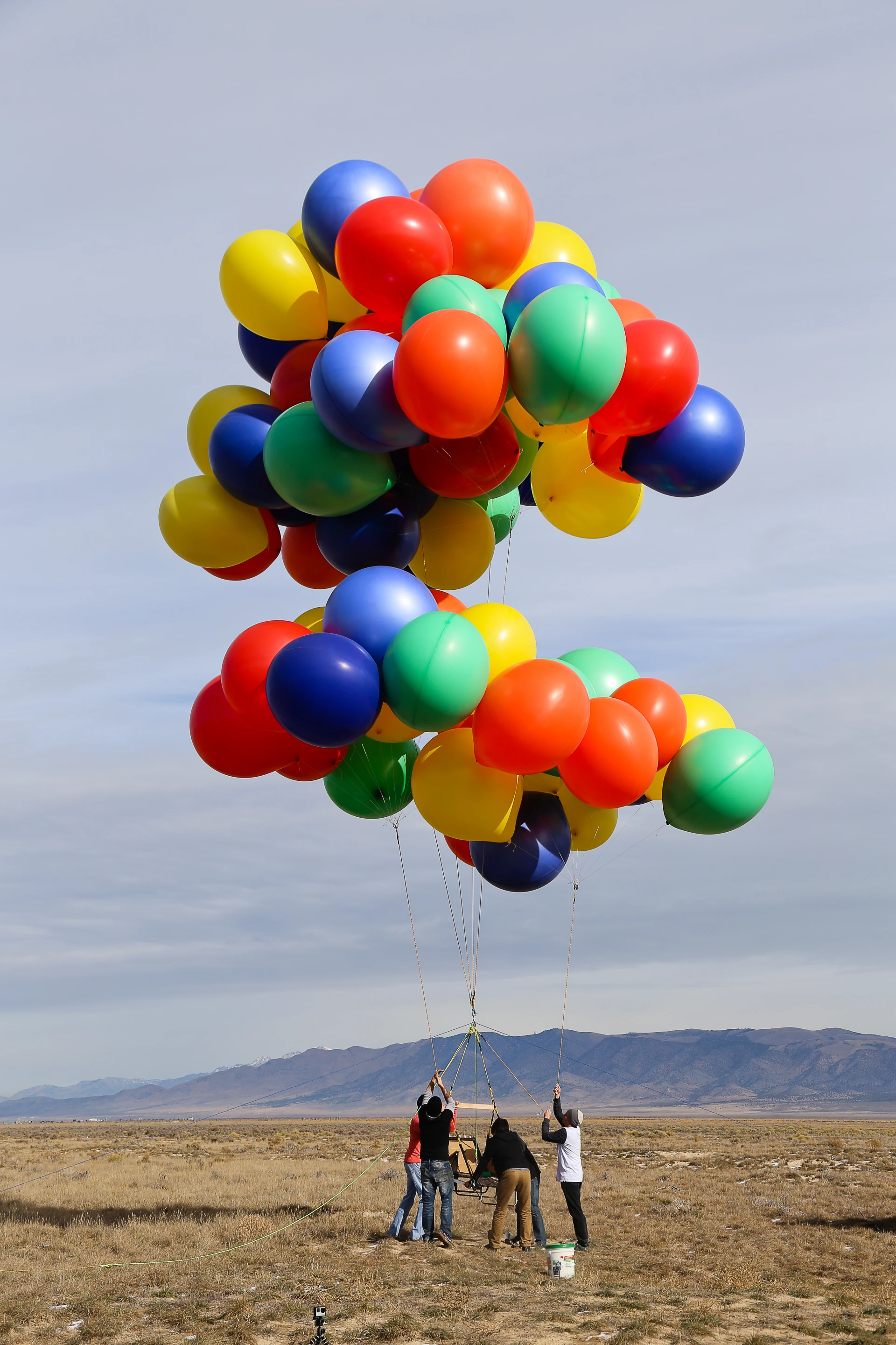 Two groups of balloons are attached to the sun lounger