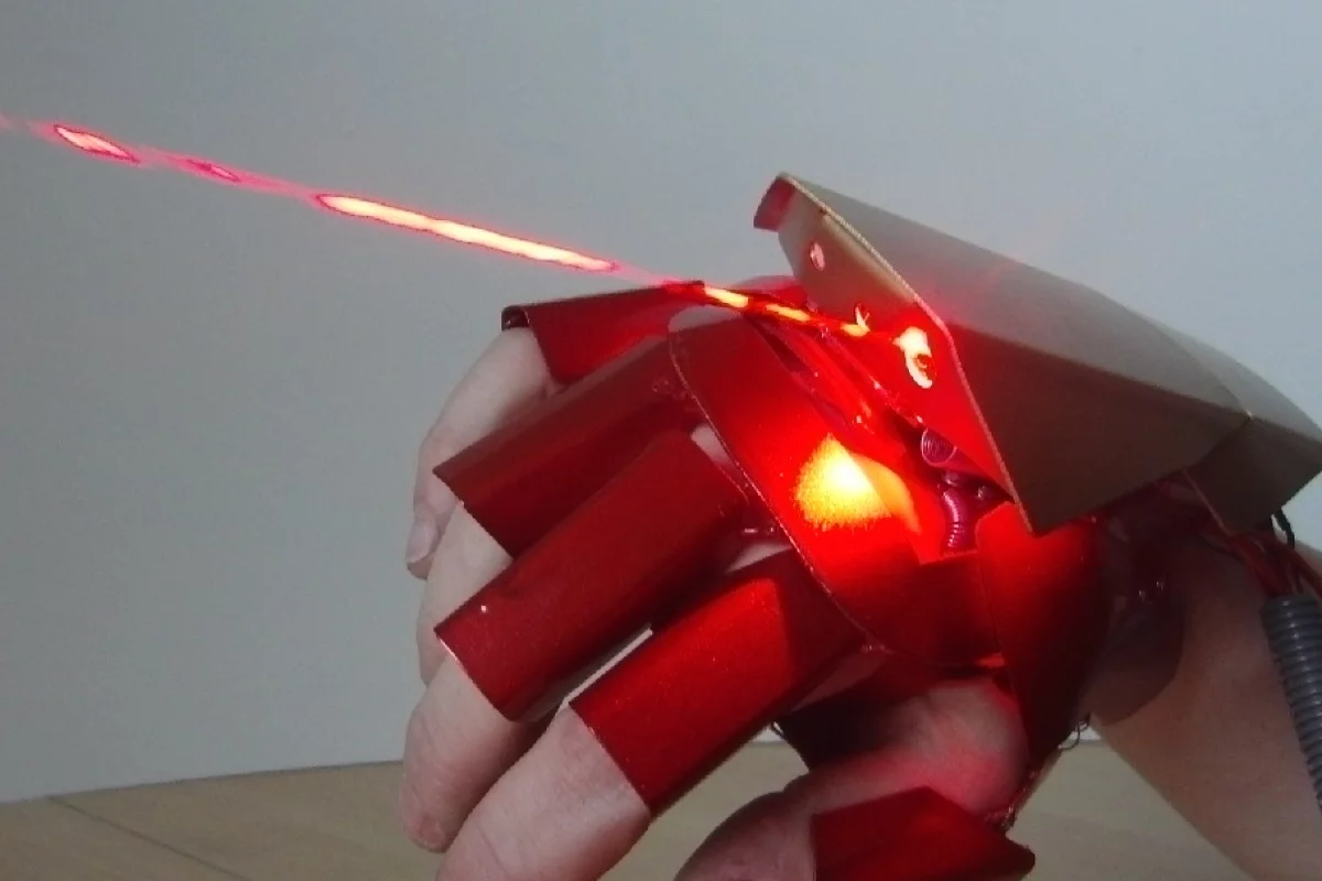 The glove features burning lasers on the top and in the palm