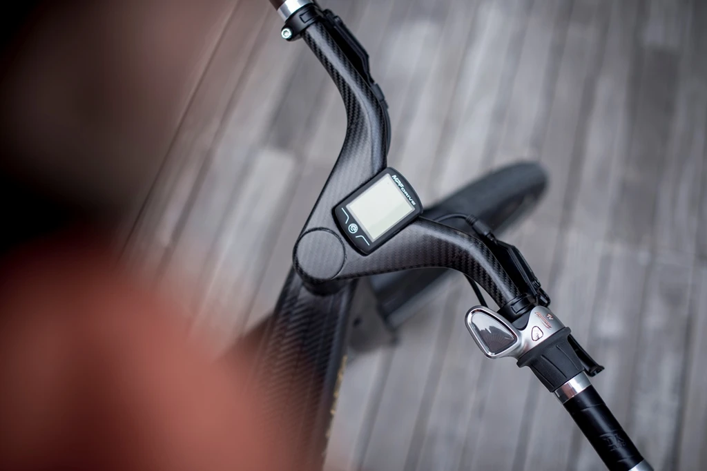 The carbon fiber handlebar has a digital display at the center