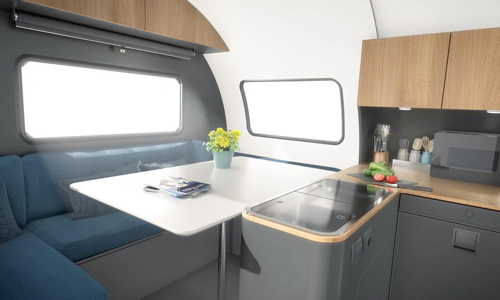 The 3XC truck camper and 3X trailer have a dining lounge with fold-away table and convertible sofa/bed