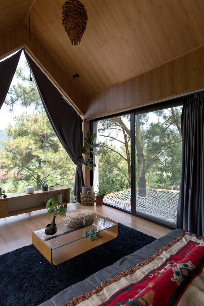 The home boasts a simple design, featuring large floor-to-ceiling glass panels
