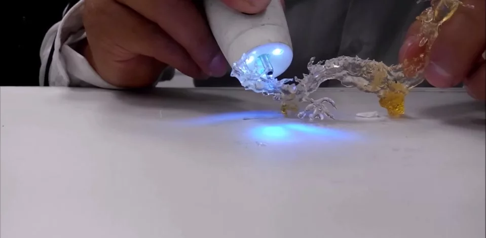 An artist sketches a dragon using the plastic polymer