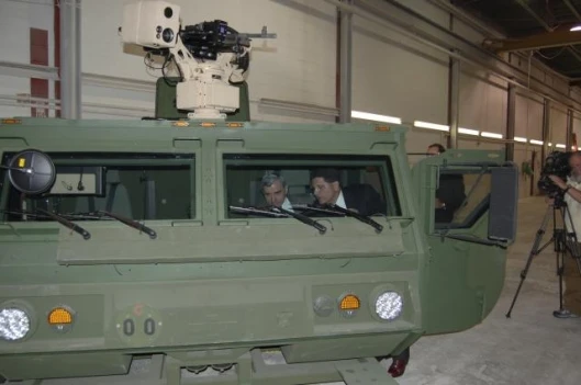 Steve Nimmer, of Oshkosh Truck Corporation, (right) demonstrates the operation of the HEMTT A3 all-composite cab to Rhode Island Senator Jack Reed (D-RI).