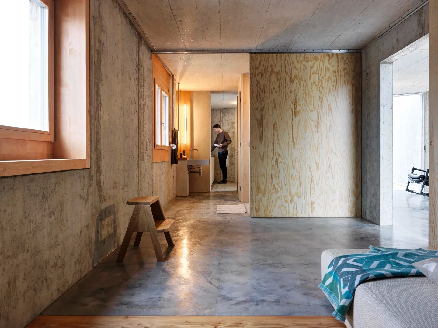 A sliding wooden door provides access to the bathroom