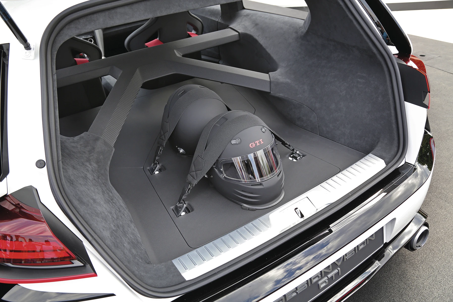 There's no rear seat, thanks to an X-shaped cross member to stiffen the GTI’s torsional rigidity, plus tie downs for racing helmets