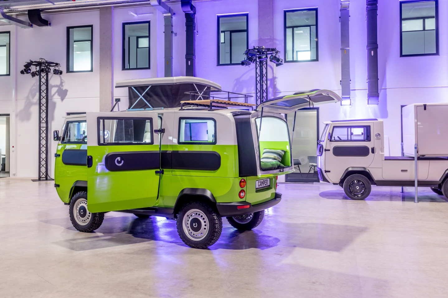 The compact Xbus camper grows by the way of a slide-out rear and pop-up roof module