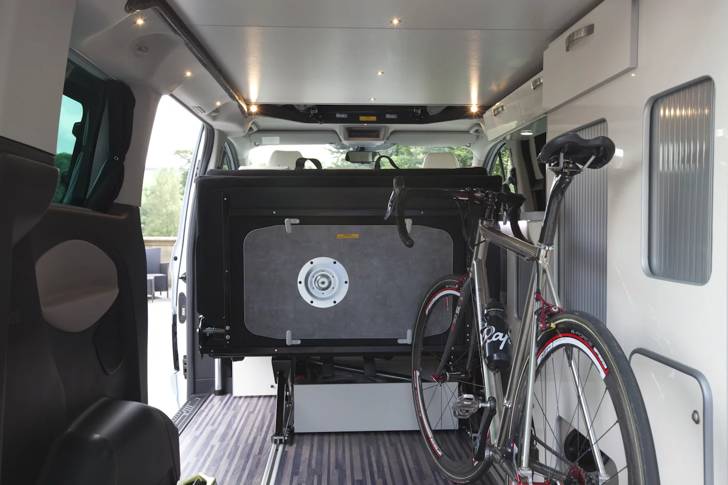 The sliding bench makes room for gear during the commute, then opens up the living area at the campground