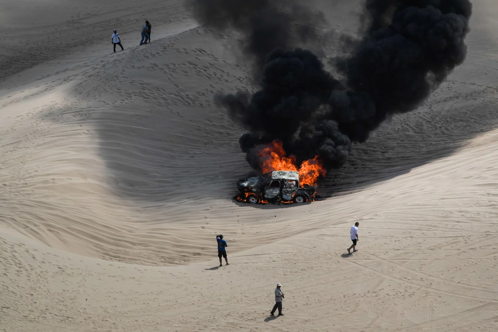 Tragic endings are all too common in the Dakar. Here Alicia Reina and Carlos Pelayo's Toyota burns in the desert – neither team member was injured