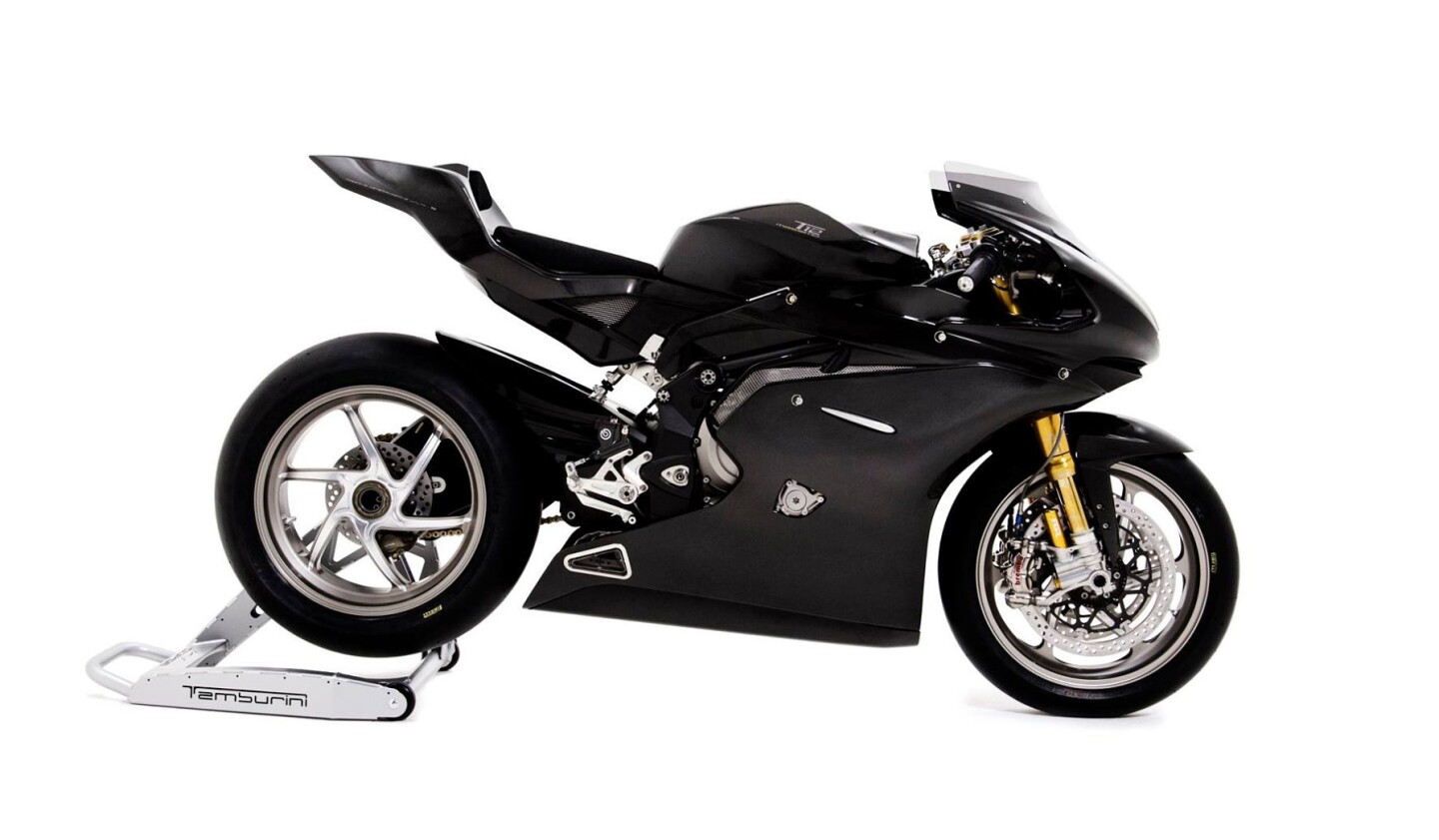 Curling up the whole exhaust system under the engine and near the center of mass is possible when there's no need for a road-legal silencer and catalyst