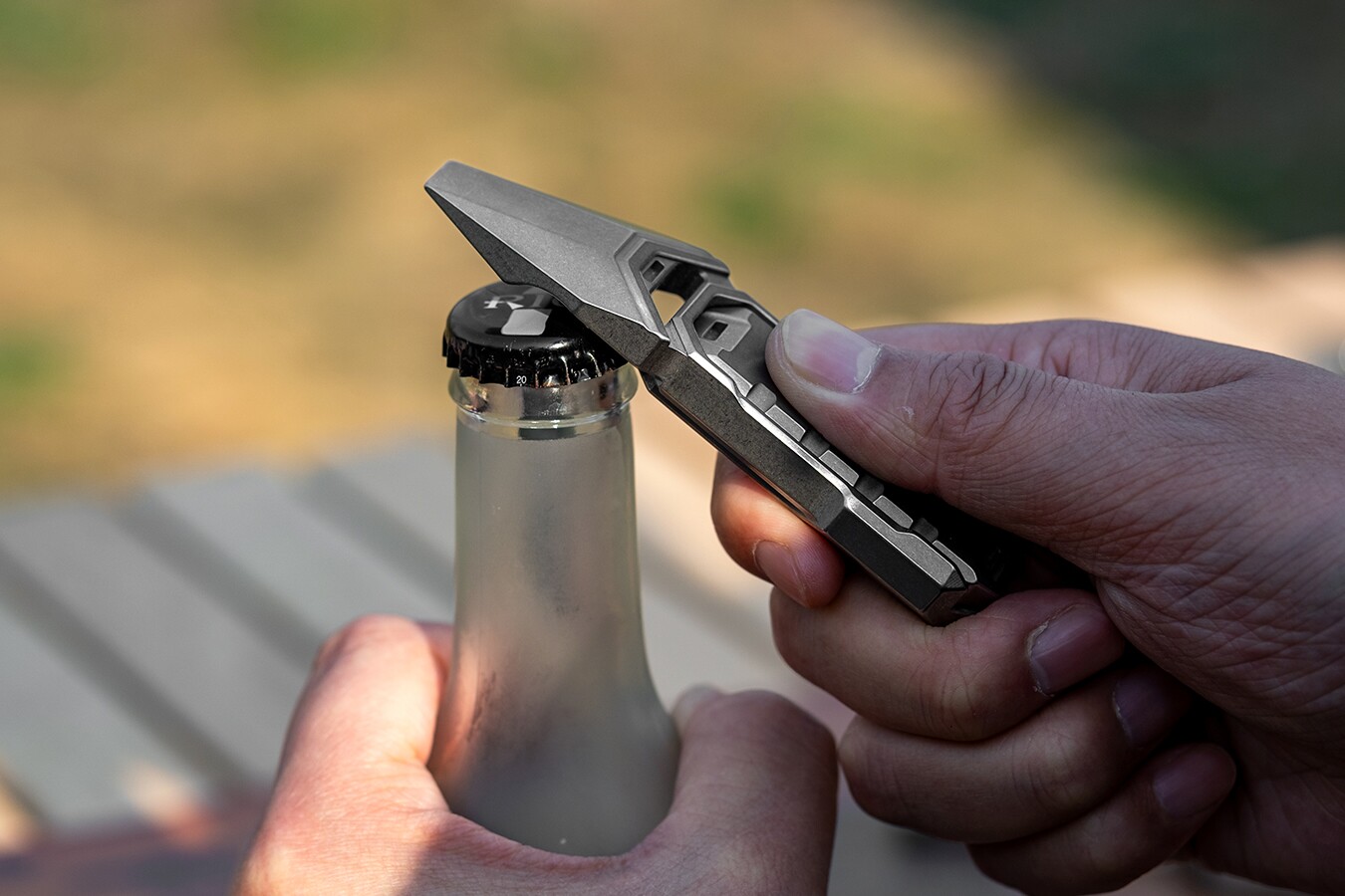 The multitool's bottle opener doing some bottle-opening