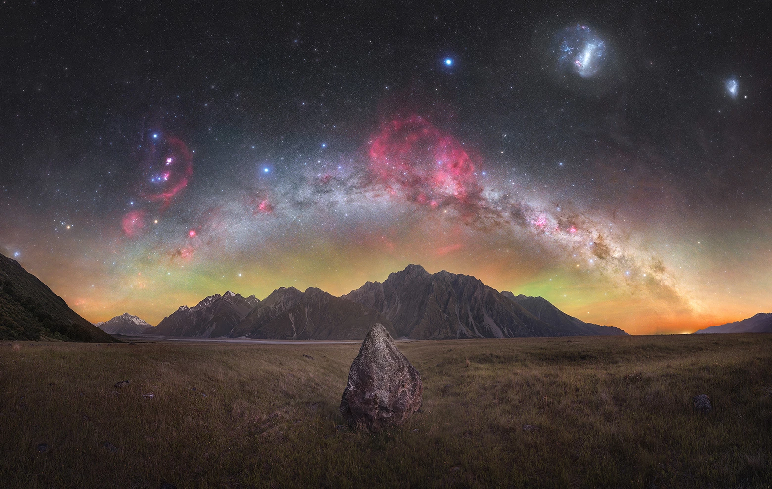 Skyscapes Winner: Tasman Gems © Tom Rae (New Zealand). Faint regions of the Milky Way like the Gum Nebula (central red region) shine in this image over the Tasman Valley, NZ