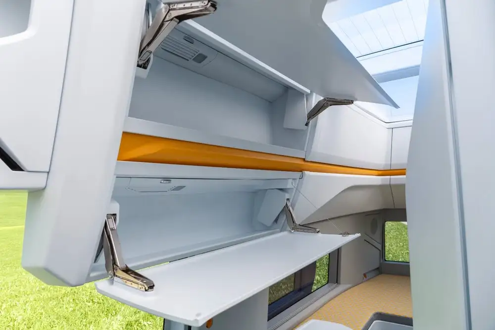 Instead of a single refrigerator box, VW has an under-counter fridge drawer and an overhead fridge cabinet