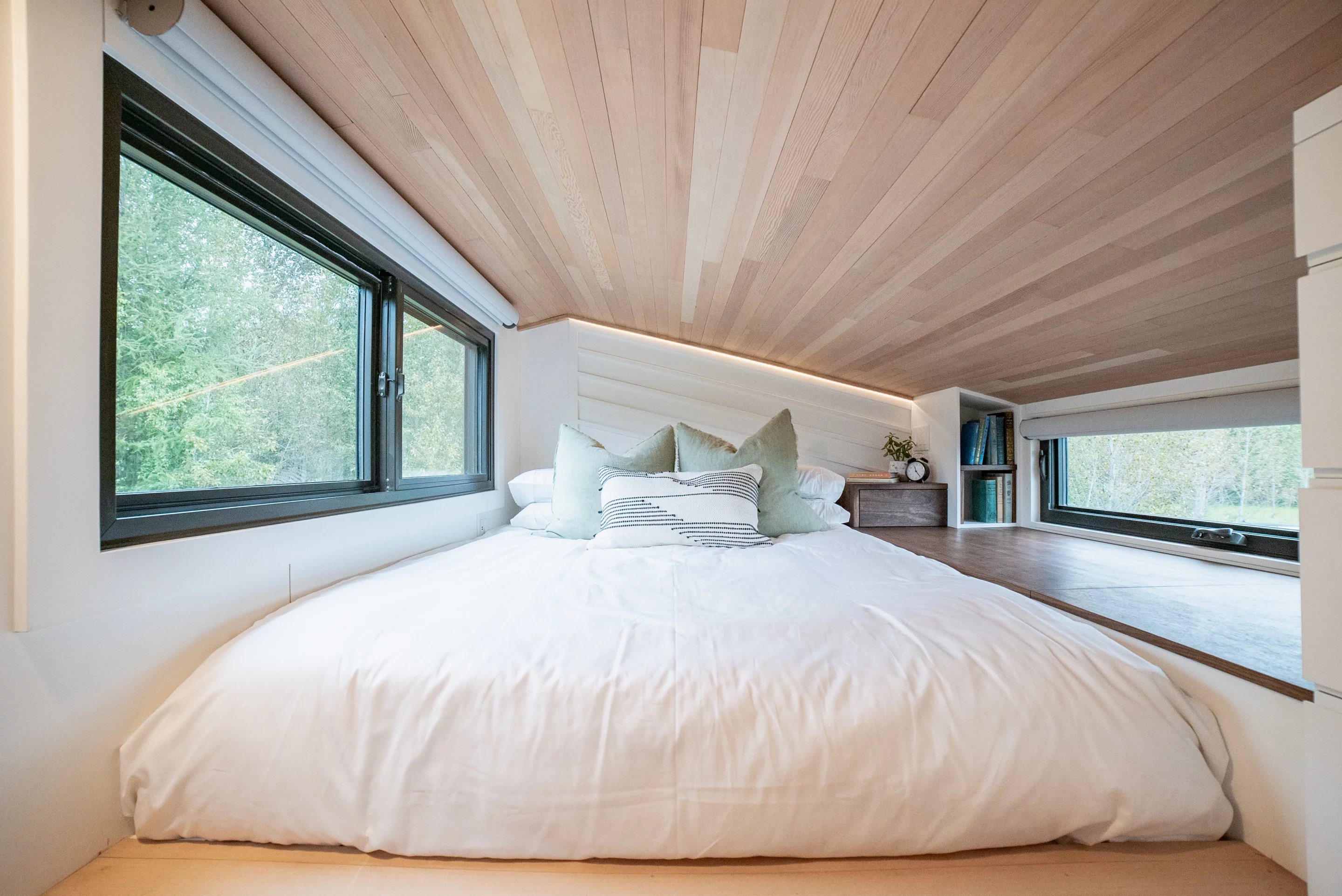 The Trahan Tiny House's bedroom is a typical tiny house-style loft bedroom with a low ceiling