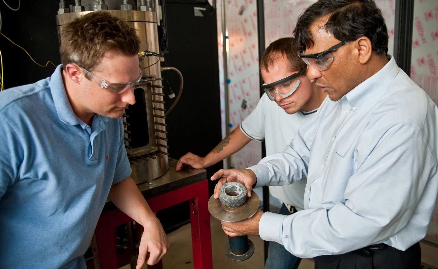 Dr. Ajay Agrawal, right, with graduate students Justin Williams, left, and Joseph Meadows, center, examine the noise reduction device, or noise sponge (Photo: Zach Riggins, University of Alabama)