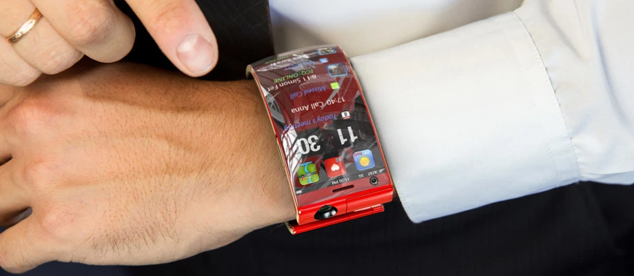 The upper screen auto activates as the arm is raised, while the lower screen turns on when it's pointed upwards by twisting the wrist