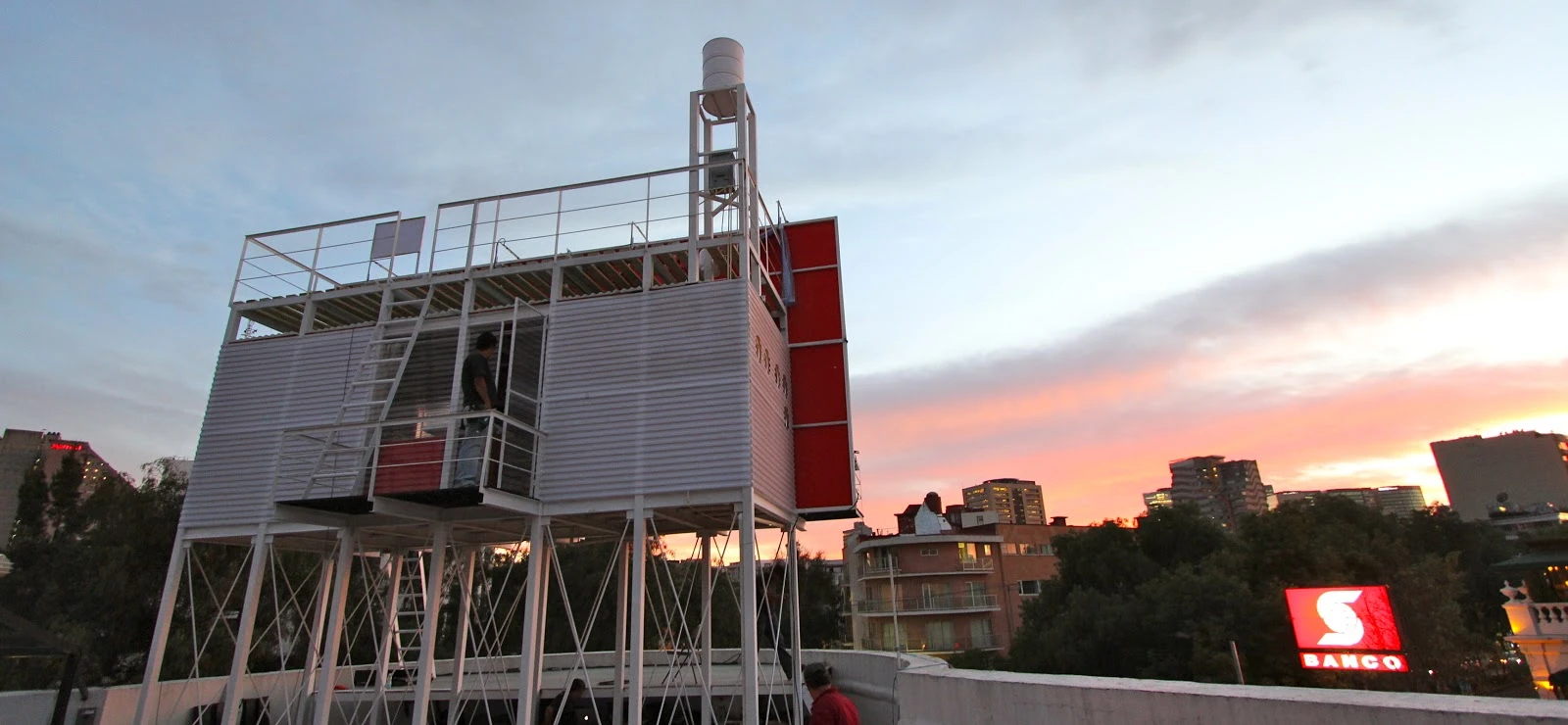 The Billboard House is a simple home built onto the back of a billboard in Mexico City to temporarily house an artist while she works on a new hand-painted advertisement