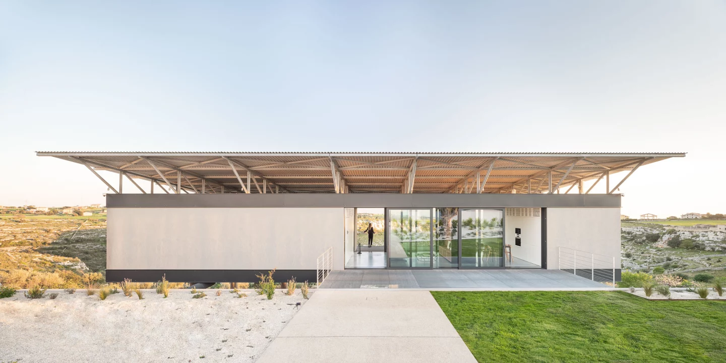 Casa VCS balances on 12 slim pillars, allowing the house to appear as if it is floating above the dramatic rocky landscape