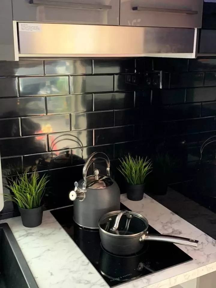 Tile backsplash behind the two-burner cooktop