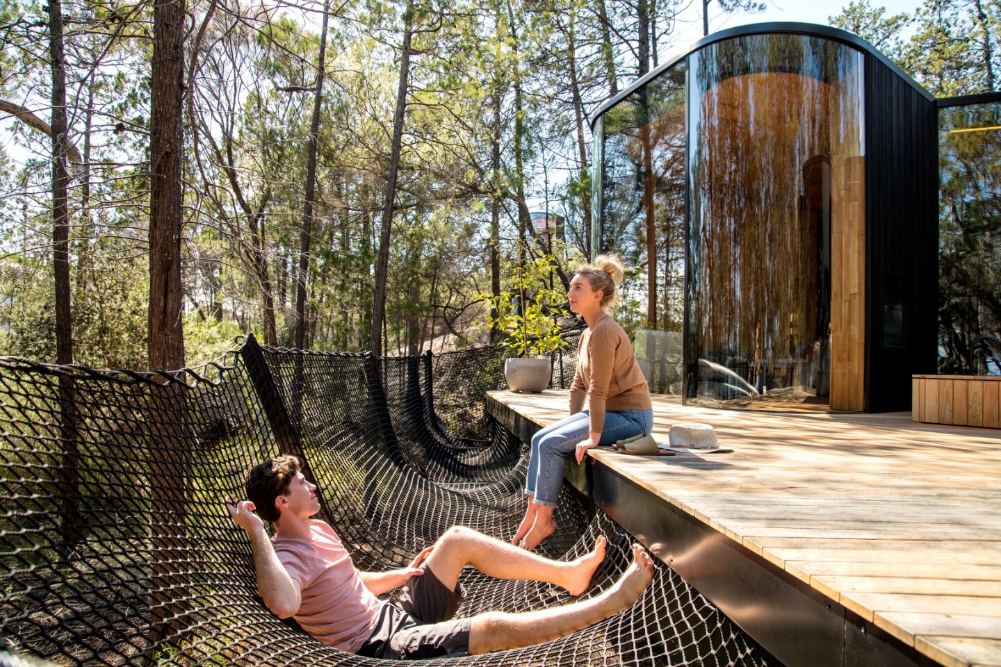 Netted hammocks have been used around the edges of the decking of the Freycinet Lodge coastal pavilions