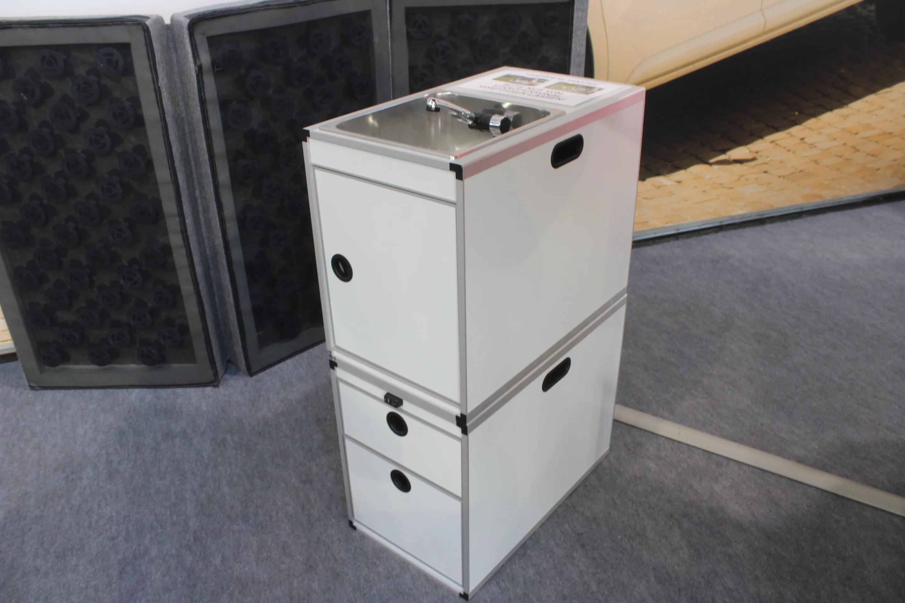 Pössl shows the Campbox kitchen modules stacked up; fold the sink faucet all the way down and the top can hold the stove