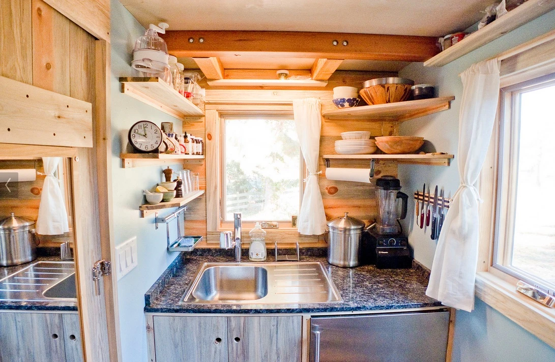 Shelving takes up the height of the kitchen walls