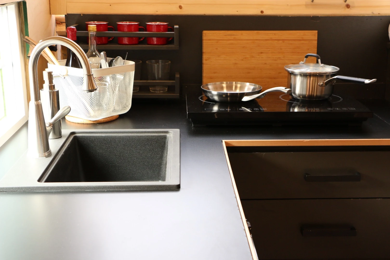 The relatively large kitchen with induction cooktop and mini refrigerator