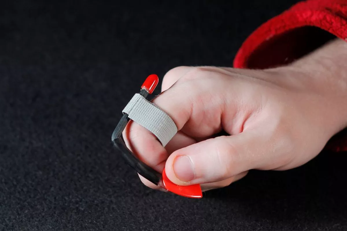 The Pick Slinger lets players grip a plectrum and then flick it out of the way when in the mood for neck tapping or finger picking