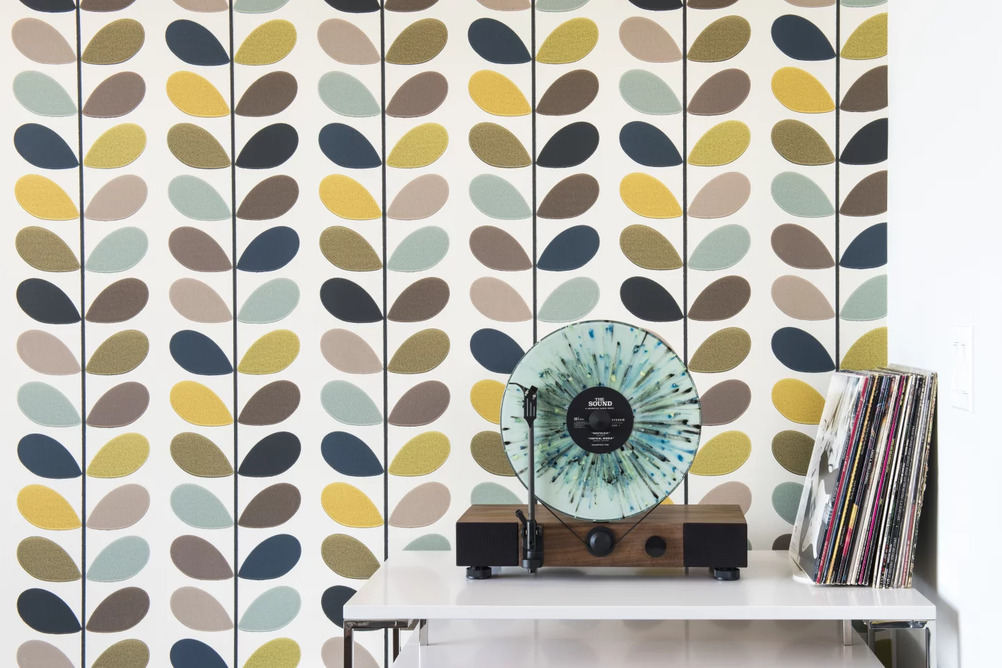 The Floating Record's platter and tonearm are both vertical and the walnut or maple body housing the electronics, speakers and drive motor is horizontal