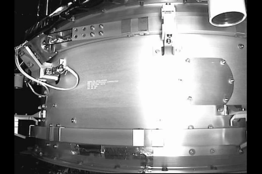 Still image from the Orbital Express Manipulator camera. This image is of the sep ring that is currently holding ASTRO and NEXTSat together. The Sep Ring will be ejected during Scenario 1-1 operations. In the upper right of the picture one of the AVGS lon
