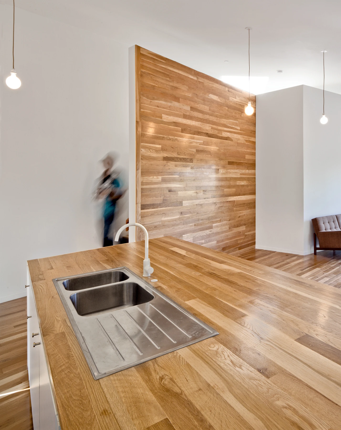 The kitchen countertop, feature wall, and floors are all constructed from white oak (Photo: Steve King)