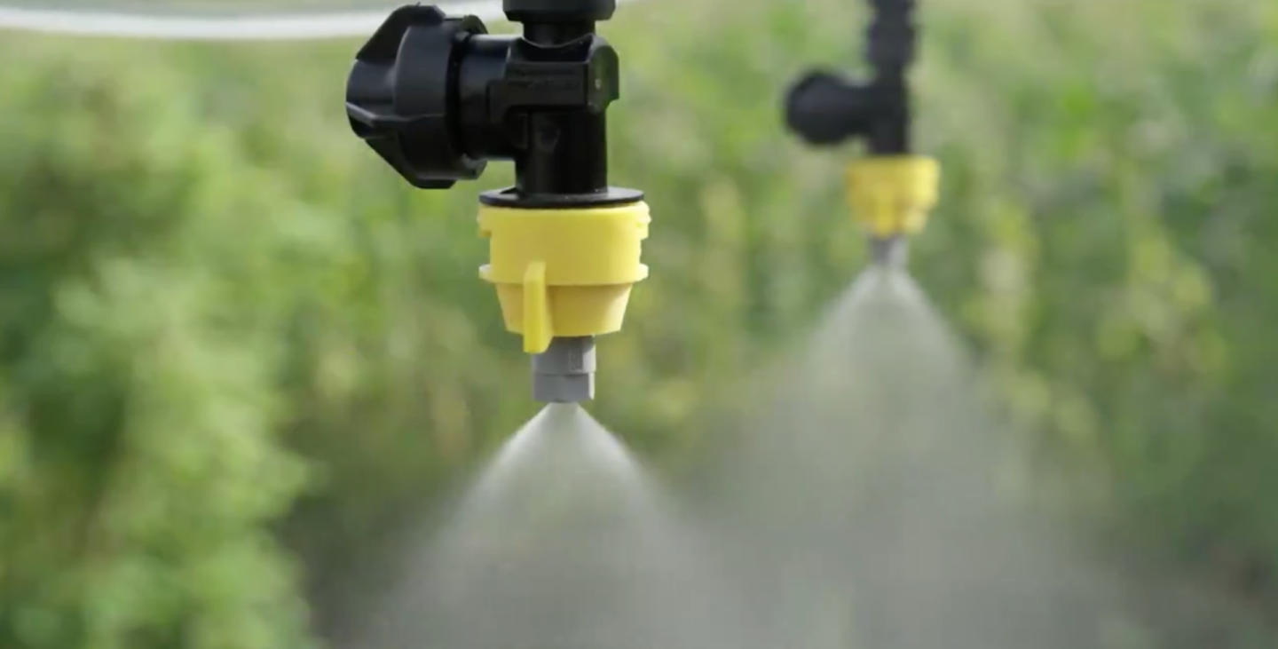 Under the drone's body is a tank for carrying chemicals, which are fed through four downward facing nozzles via a pressure sprayer system