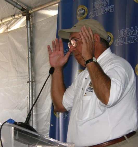 Articulate and down-to-earth DARPA Director Dr Tony Tether explains the proceedings to the assembled press
