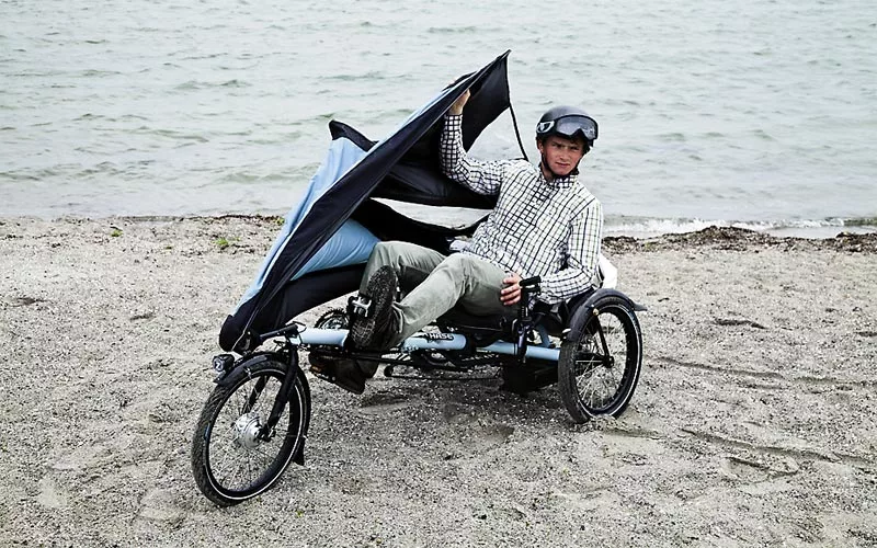 Hase Bikes' KLIMAX tricycle features a detachable folding fairing, allowing users to add weather protection as needed