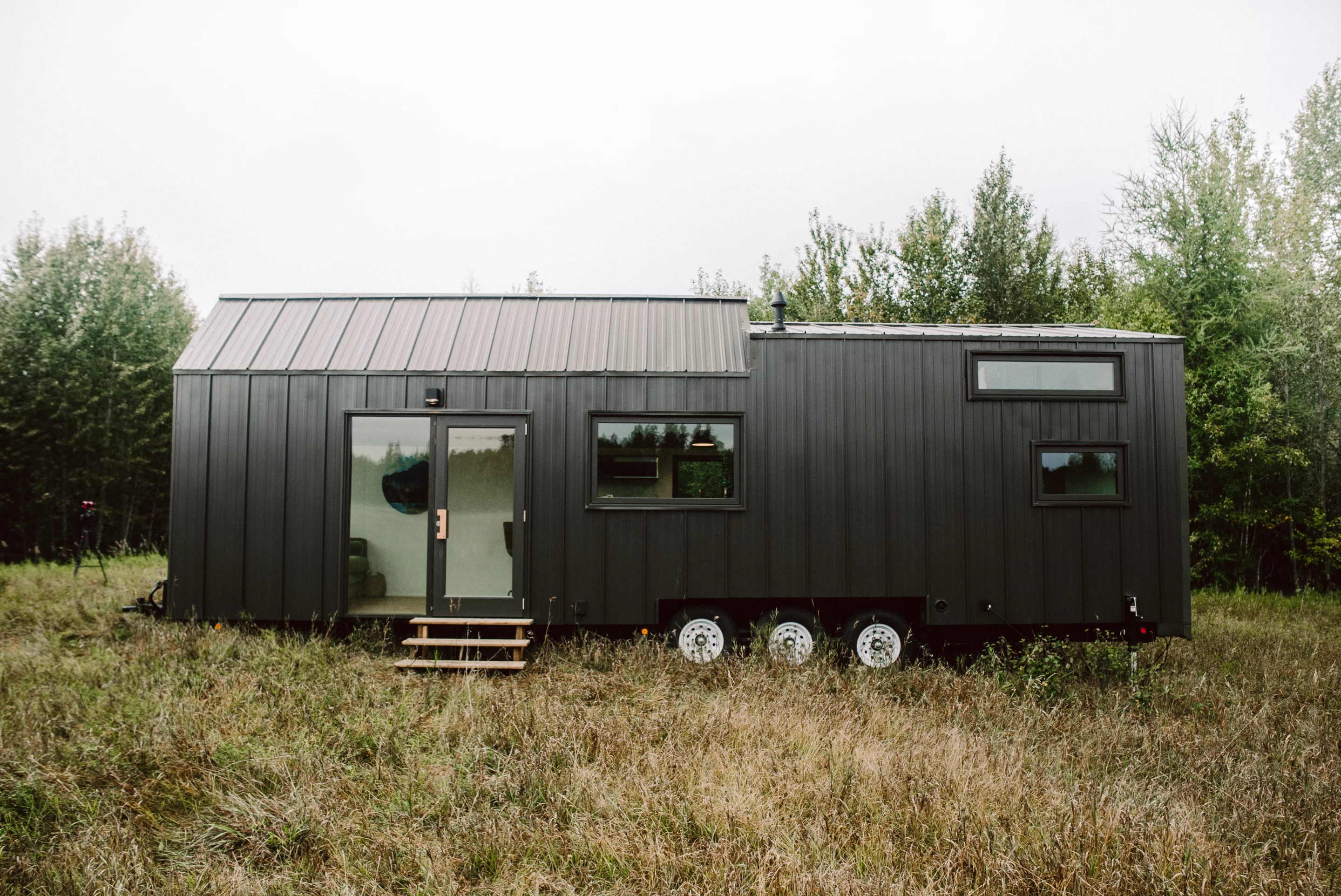 The Trahan Tiny House's overall design is envisioned as a mixture of an A-frame cabin and a mid-century modern mansion