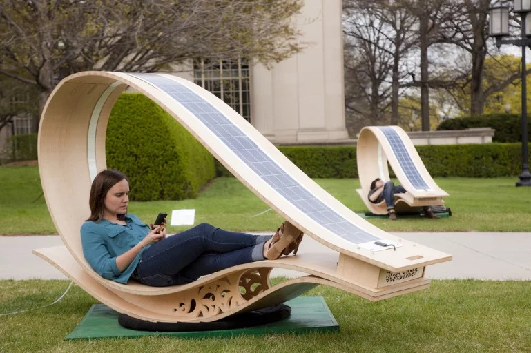 Developed for MIT's Festival of Art Science Technology, the SOFT Rockers use enhanced fabrication techniques to curve flat wooden panels, and have solar panels installed to charge the gadgets of those who relax within (Photo: Phil Seaton)